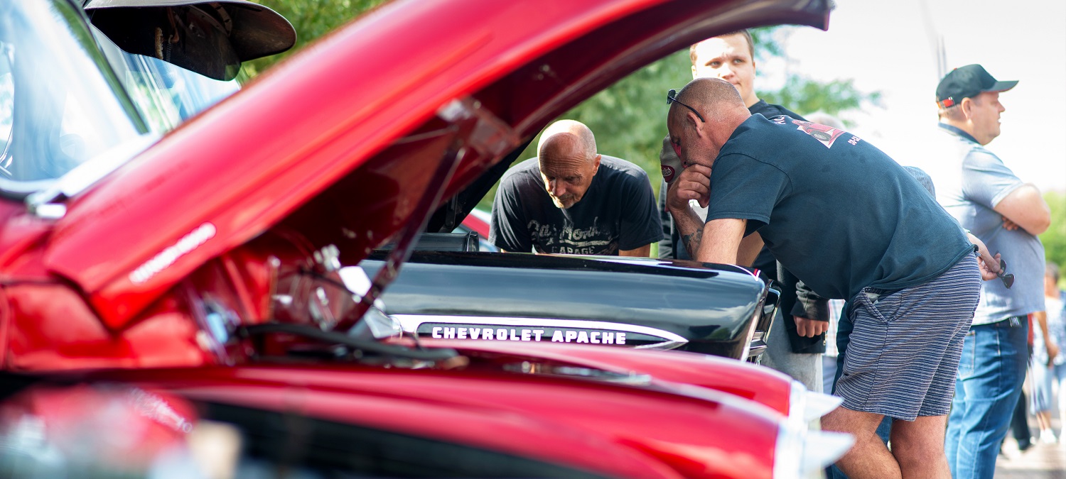 People gathered around a classic car at Port Solent